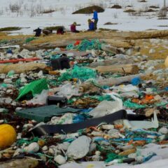 A beach littered with plastic bottles and other rubbish