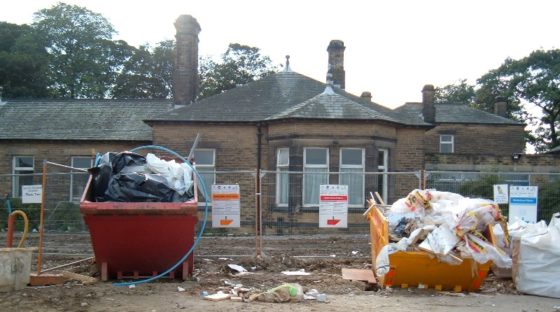 Image shows construction waste containers with waste.