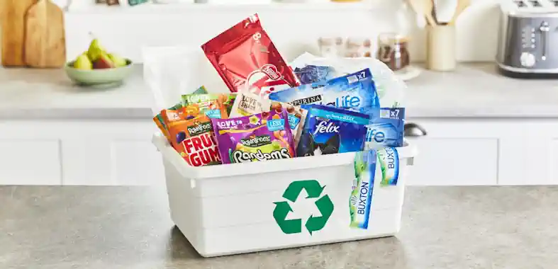 A recycling bin full of Nestle packaging.